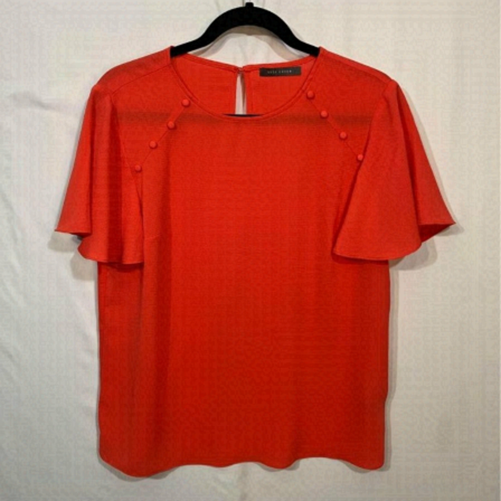 WOMAN’S coral colour blouse with button detail- flowy sleeve. Size mediu…